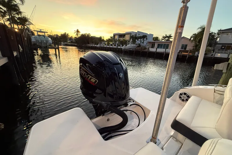 Slide: The Image of 2024 Regal LX2 boat with outboard motor at sunset on a serene waterway. - 6