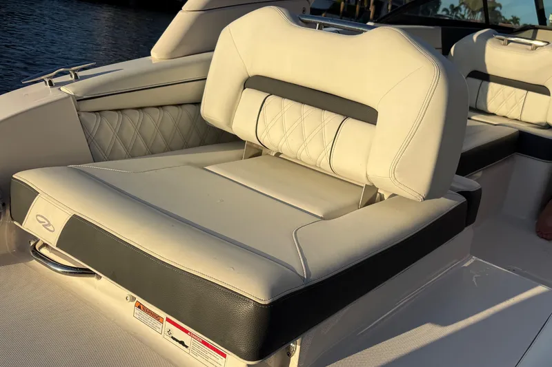 Slide: The Image of 2024 Regal LX2 boat interior with luxurious white seating and diamond stitching. - 8