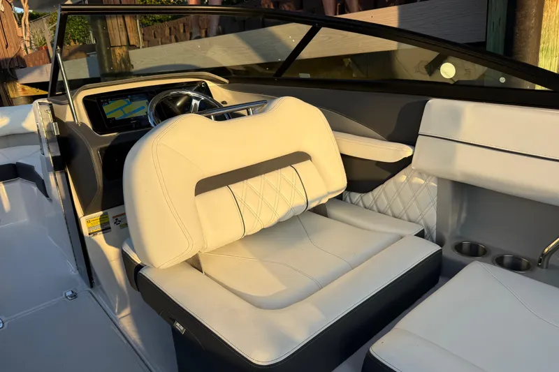 Slide: The Image of 2024 Regal LX2 boat interior with luxurious white seating and modern dashboard. - 9