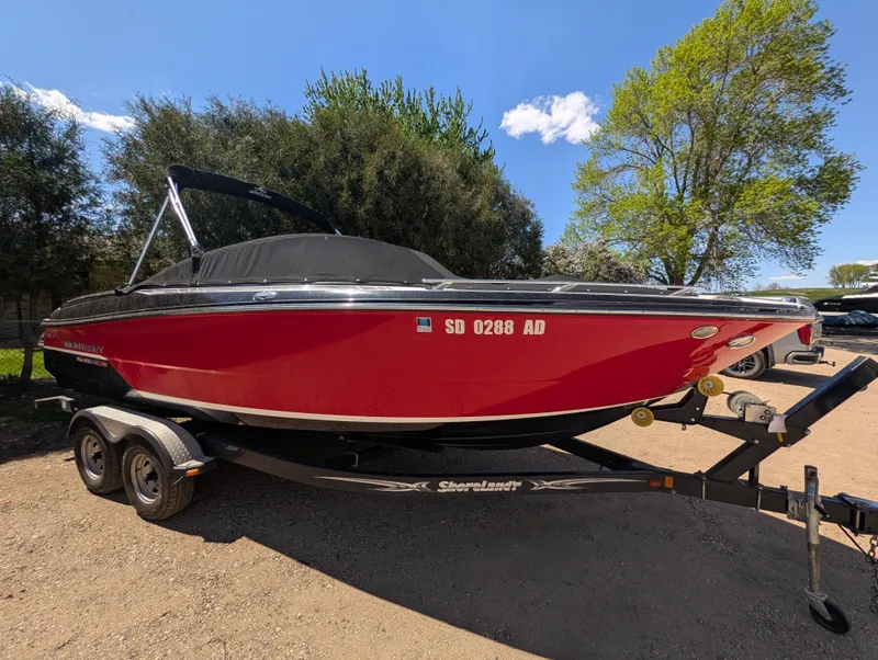 The Image of Red 2015 Monterey 238 boat parked on trailer outdoors. - 1