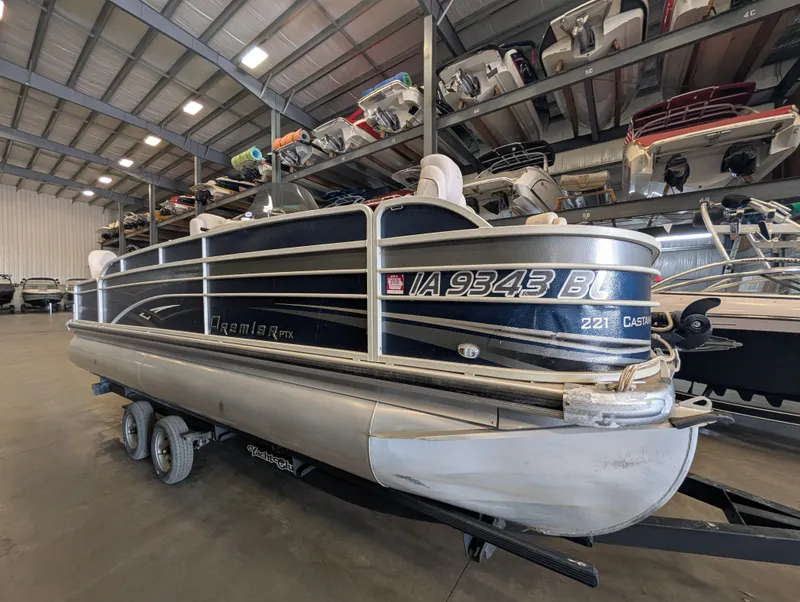 The Image of 2013 Premier 221 Castaway RE pontoon boat in storage facility. - 1