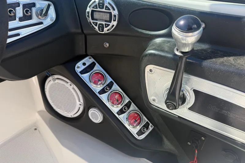 Slide: The Image of 2006 MasterCraft X-15 boat dashboard with gauges, controls, and audio system. - 11