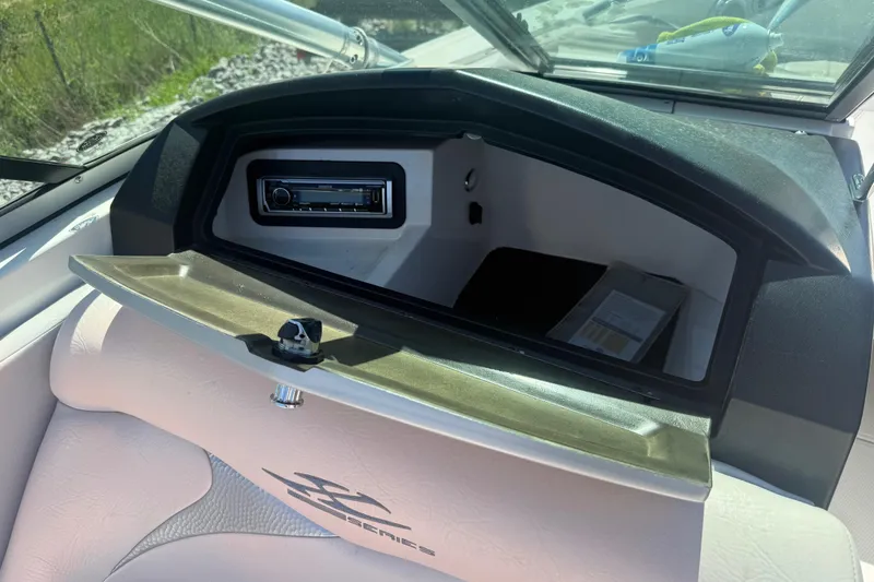 Slide: The Image of 2006 MasterCraft X-15 boat dashboard with open glove compartment and stereo system. - 14