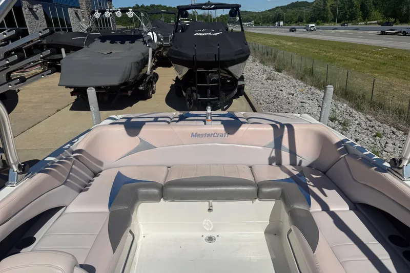 Slide: The Image of 2006 MasterCraft X-15 boat interior with seating, parked near highway. - 16