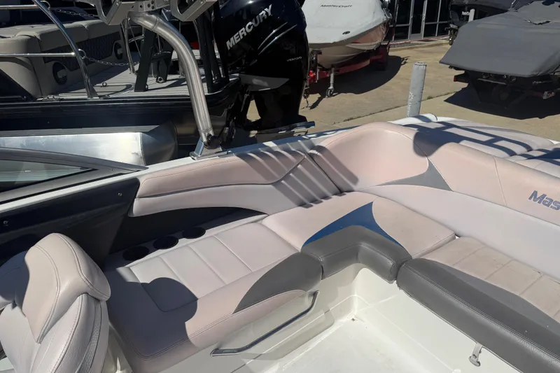 Slide: The Image of 2006 MasterCraft X-15 boat interior with cushioned seating and Mercury engine in background. - 17
