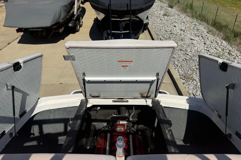 Slide: The Image of Open engine compartment of a 2006 MasterCraft X-15 boat, showing engine details. - 18