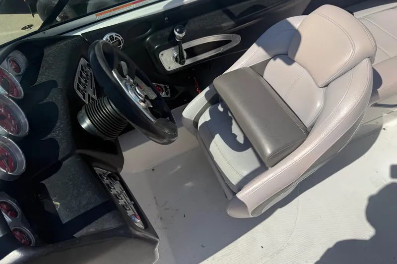 Slide: The Image of 2006 MasterCraft X-15 boat interior with steering wheel and captain's seat. - 4