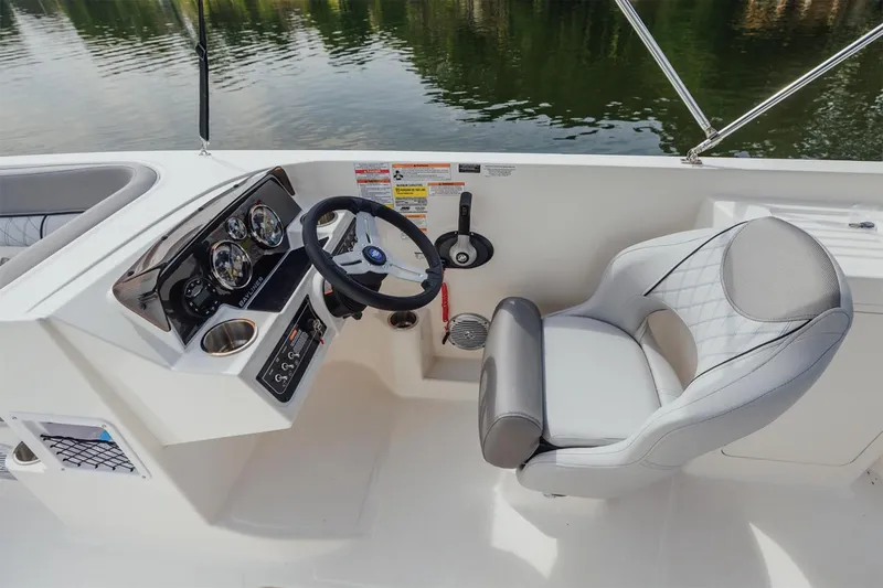Slide: The Image of Manufacturer Provided Image: 2025 Bayliner D22I boat cockpit with steering wheel and comfortable seating. - 4