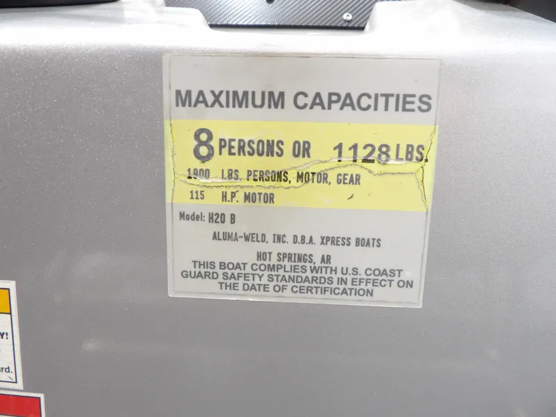 Slide: The Image of 2019 Xpress H20B Bay boat capacity label, 8 persons, 1128 lbs. - 18