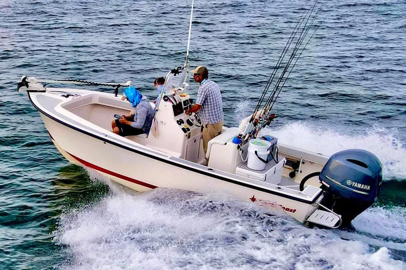 Slide: The Image of Manufacturer Provided Image: 2026 NorthCoast 190 Center Console boat cruising on the water with two passengers. - 12