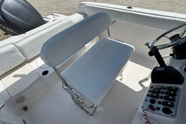 Slide: The Image of 2011 Starcraft Star Step 229 CC OB boat interior with white seating and control panel. - 15