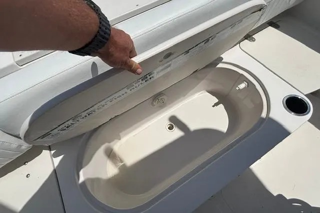 Slide: The Image of 2011 Starcraft Star Step 229 CC OB boat with open storage compartment. - 17