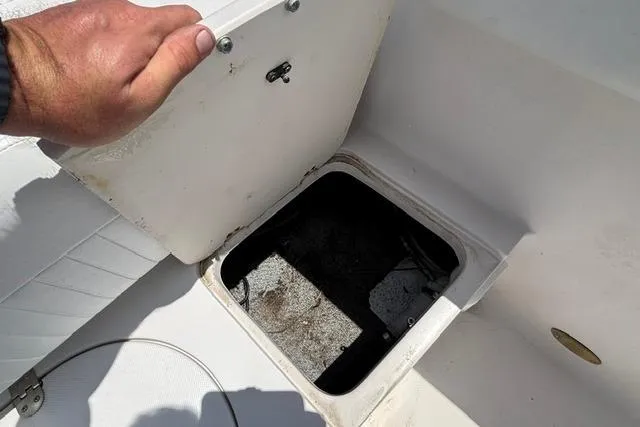 Slide: The Image of Open storage compartment on a 2011 Starcraft Star Step 229 CC OB boat. - 18
