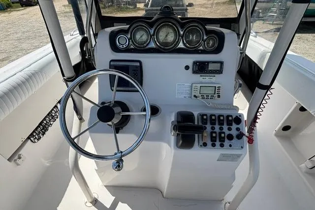Slide: The Image of 2011 Starcraft Star Step 229 CC OB boat dashboard with steering wheel and control panel. - 19