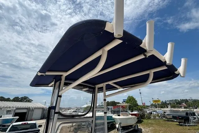 Slide: The Image of 2011 Starcraft Star Step 229 CC OB boat with blue canopy and rod holders. - 22