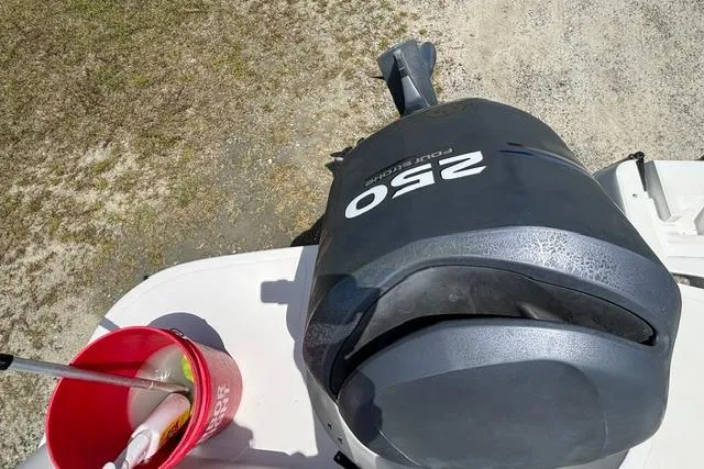 Slide: The Image of Outboard motor on 2011 Starcraft Star Step 229 CC OB with cleaning supplies nearby. - 25