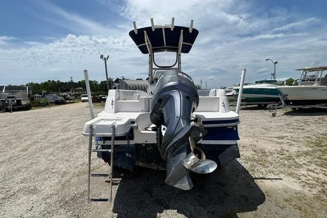 Slide: The Image of 2011 Starcraft Star Step 229 CC OB boat with outboard motor, parked on gravel lot. - 5