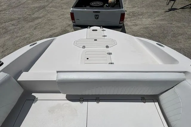Slide: The Image of 2011 Starcraft Star Step 229 CC OB boat interior with white seating and storage compartments. - 7
