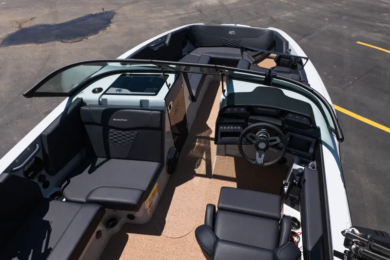 Slide: The Image of 2026 MasterCraft NXT24 boat interior with sleek seating and modern dashboard design. - 13