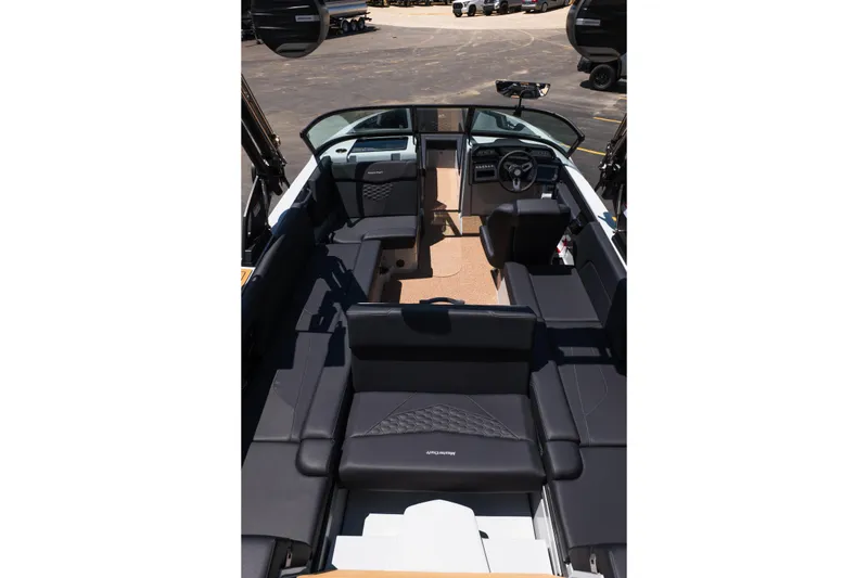 Slide: The Image of 2026 MasterCraft NXT24 boat interior with sleek black seating and modern dashboard design. - 16