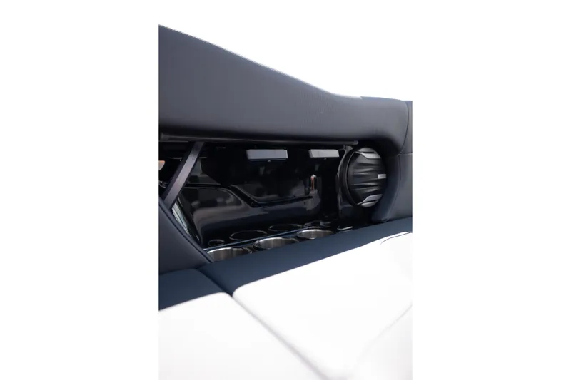 Slide: The Image of Interior detail of 2026 MasterCraft NXT24 boat, featuring sleek design and cup holders. - 20