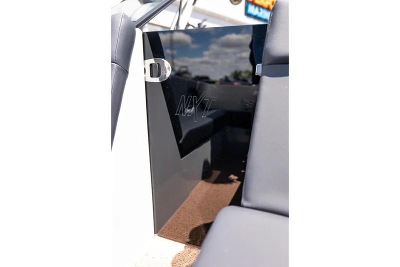 Slide: The Image of 2026 MasterCraft NXT24 boat interior with sleek black panel and cushioned seating. - 21