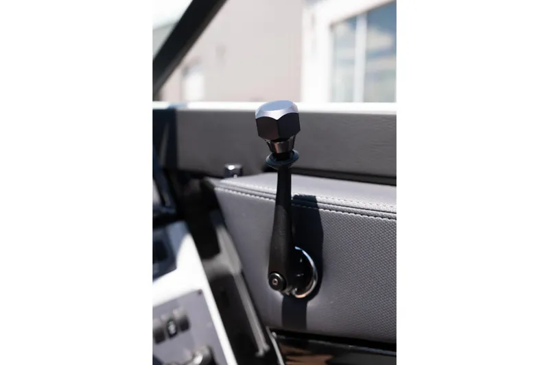 Slide: The Image of Close-up of 2026 MasterCraft NXT24 boat throttle lever, showcasing sleek design and craftsmanship. - 23