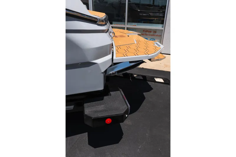 Slide: The Image of 2026 MasterCraft NXT24 boat rear view with hexagonal deck pattern. - 7