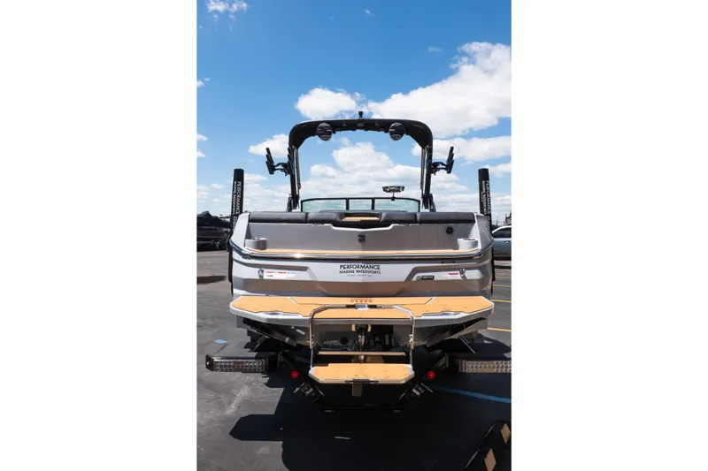 Slide: The Image of 2026 MasterCraft NXT24 boat rear view under a clear blue sky. - 9