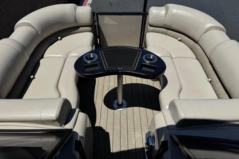 Slide: The Image of Luxurious seating area on 2023 Avalon Catalina VRBW boat with elegant table and cup holders. - 11
