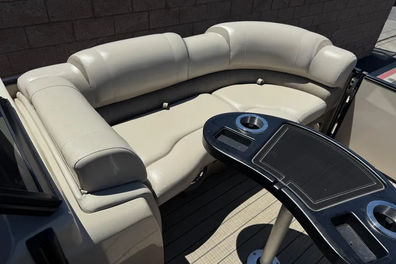 Slide: The Image of Luxurious seating area on 2023 Avalon Catalina VRBW pontoon boat with table and cup holders. - 12