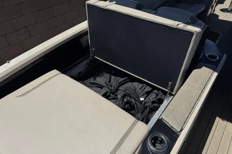 Slide: The Image of 2023 Avalon Catalina VRBW boat storage compartment with open lid and interior view. - 20