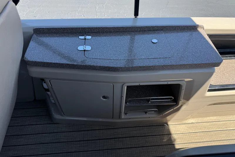 Slide: The Image of 2023 Avalon Catalina VRBW boat interior with sleek countertop and storage compartments. - 24