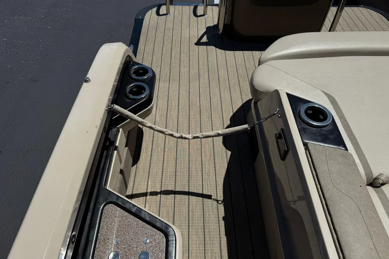 Slide: The Image of 2023 Avalon Catalina VRBW boat interior with beige seating and cup holders. - 27