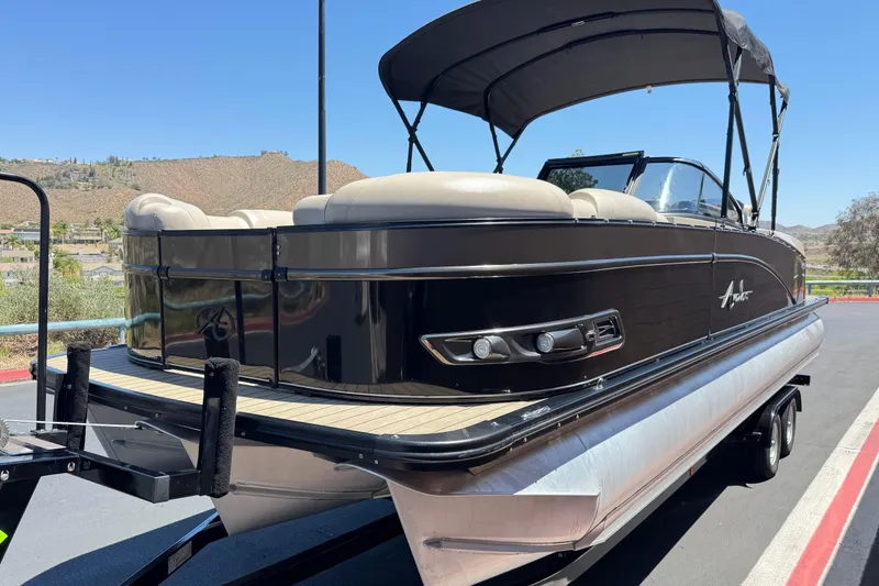 Slide: The Image of 2023 Avalon Catalina VRBW pontoon boat with sleek black design and comfortable seating. - 3