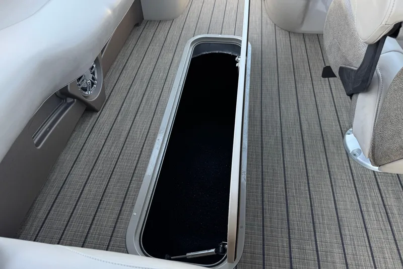 Slide: The Image of 2023 Avalon Catalina VRBW boat interior with open storage compartment on striped flooring. - 31