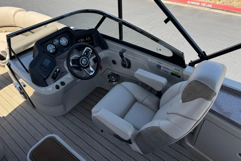 Slide: The Image of 2023 Avalon Catalina VRBW boat cockpit with steering wheel and comfortable captain's chair. - 32
