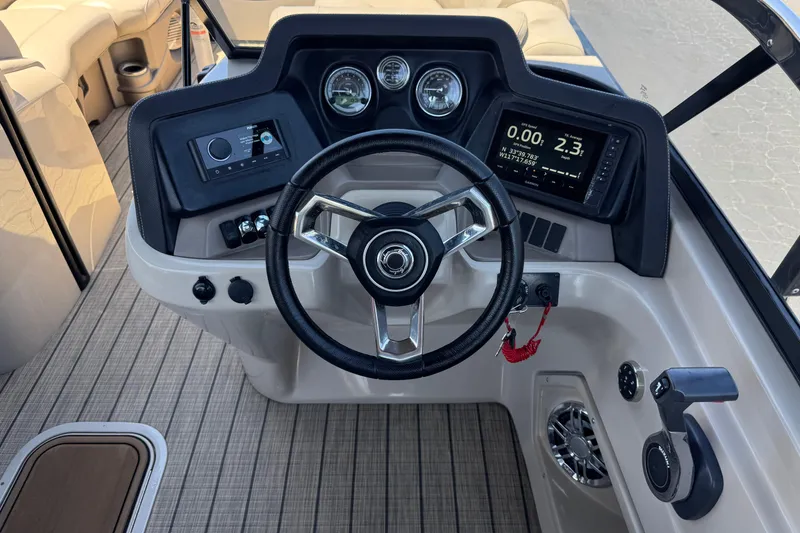 Slide: The Image of 2023 Avalon Catalina VRBW boat dashboard with steering wheel and navigation controls. - 33