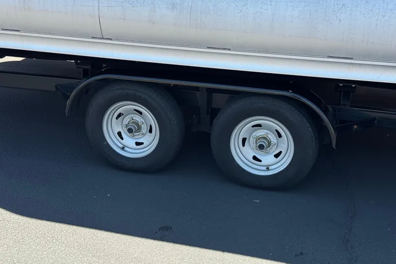 Slide: The Image of Dual wheels of a 2023 Avalon Catalina VRBW trailer on asphalt surface. - 37