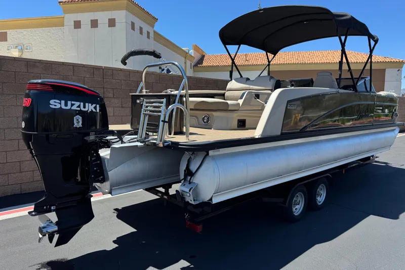 Slide: The Image of 2023 Avalon Catalina VRBW pontoon boat with Suzuki outboard motor on trailer. - 6