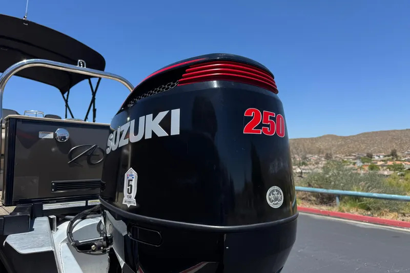 Slide: The Image of Suzuki 250 outboard motor on 2023 Avalon Catalina VRBW boat under clear blue sky. - 8