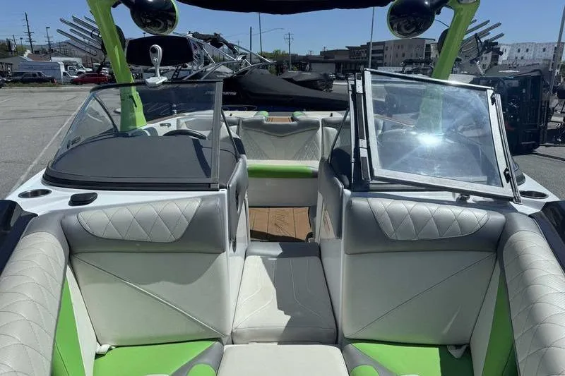Slide: The Image of 2015 Tigé Z1 boat on trailer, green and white design, parked outdoors. - 11