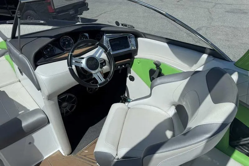 Slide: The Image of Interior of a 2015 Tigé Z1 boat featuring a sleek dashboard and comfortable seating. - 4