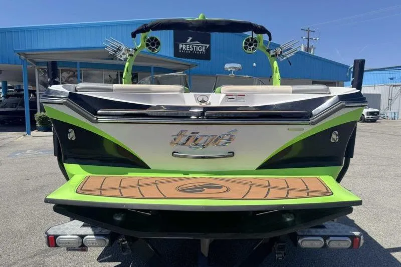 Slide: The Image of 2015 Tigé Z1 boat with vibrant green accents at Prestige Water Sports dealership. - 6