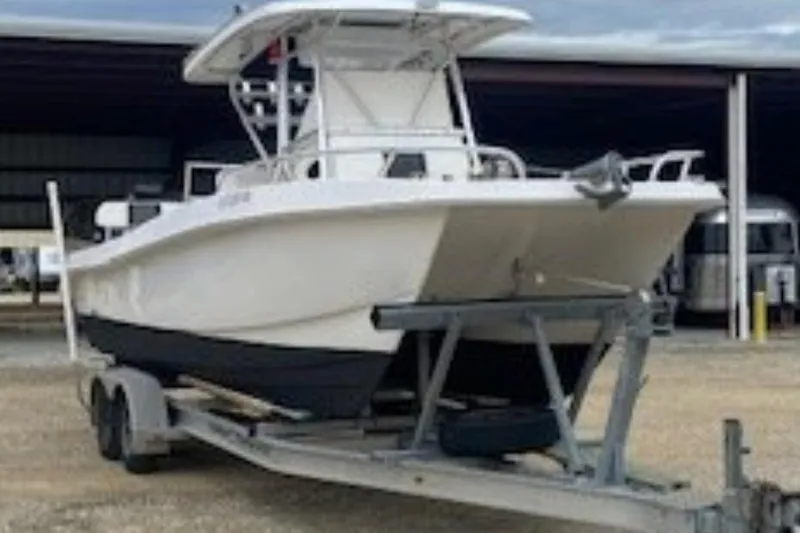 Slide: The Image of 2016 Twin Vee 26 Center Console boat on trailer with dual outboard engines. - 3