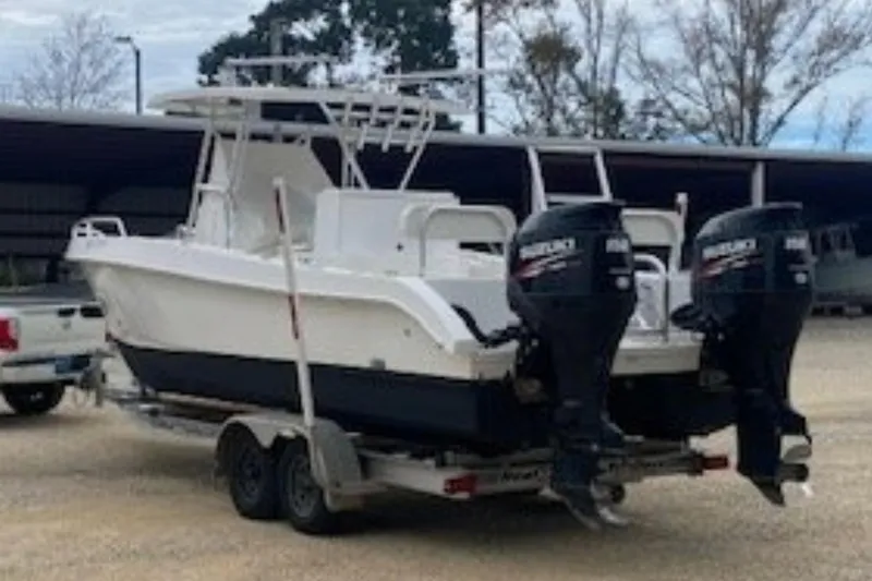 Slide: The Image of 2016 Twin Vee 26 Center Console boat with dual 150 horsepower engines on trailer. - 4