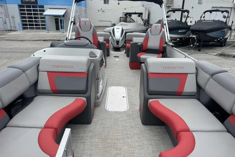 Slide: The Image of 2022 Trifecta SS 23RF pontoon boat interior with gray and red seating. - 11