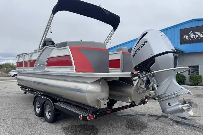 Slide: The Image of 2022 Trifecta SS 23RF pontoon boat with Honda outboard motor on trailer. - 12