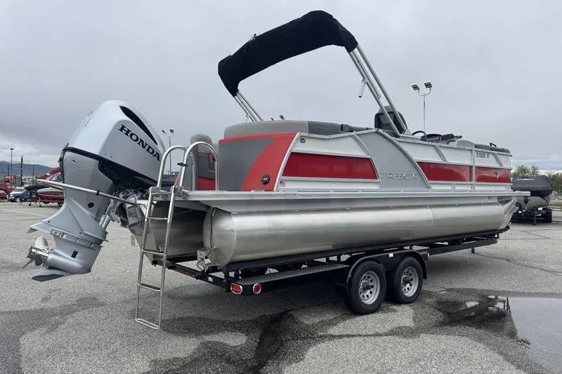 Slide: The Image of 2022 Trifecta SS 23RF pontoon boat with Honda outboard motor on trailer. - 15