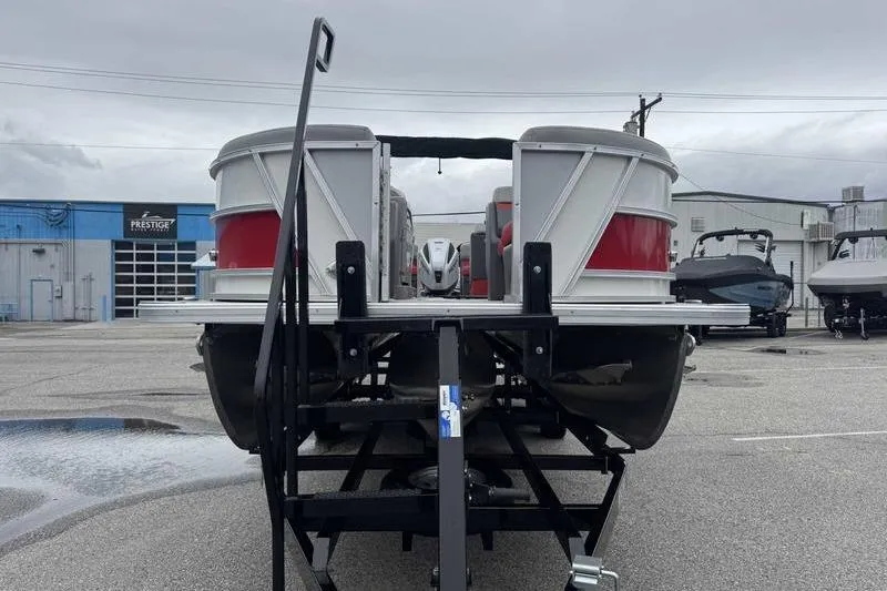 Slide: The Image of 2022 Trifecta SS 23RF pontoon boat on trailer in a parking lot. - 3